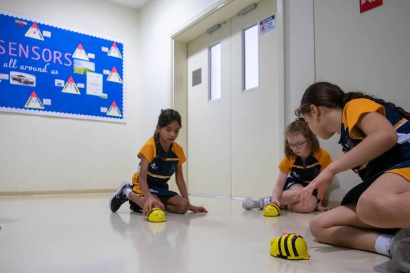 Pupils with the little yellow robots at Repton Al Barsha.