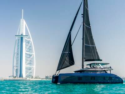 A catamaran built by Poland's Sunreef Yachts sails past Dubai’s Burj Al Arab. Sunreef