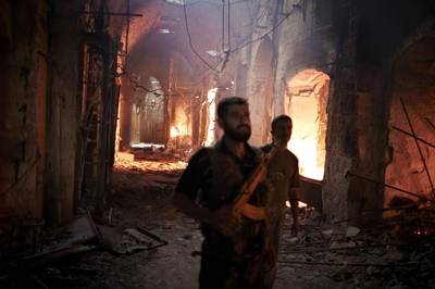 One of Aleppo's historical neighbourhoods burns during an assault by Assad's military in 2012. Courtesy Sipa USA / REX



