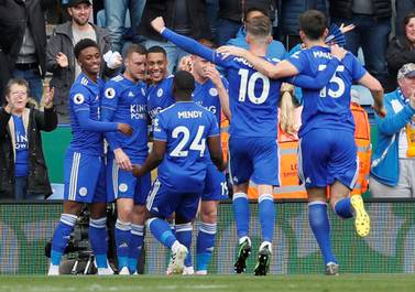 Jamie Vardy, second left, is swamped by teammates after scoring his first and Leicester City's second goal against Arsenal. Reuters