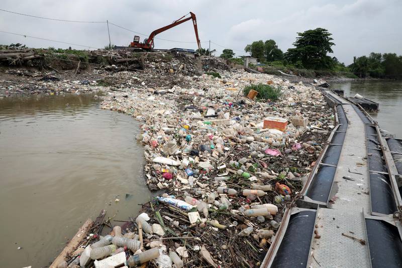 Waste collected by a log boom is seen on a river during World Environment Day, in Klang, Malaysia.  REUTERS