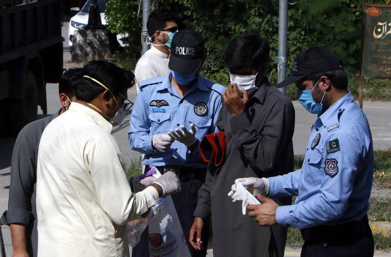 Pakistani security officials prepare to seal the area where positive cases of coronavirus were reported in Islamabad, Pakistan.  EPA