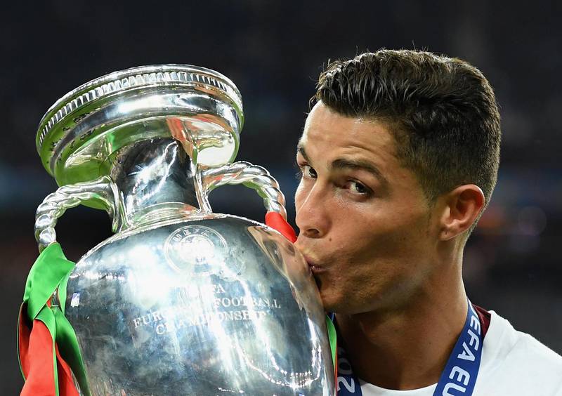 PARIS, FRANCE - JULY 10:  Cristiano Ronaldo of Portugal kisses the Henri Delaunay trophy to celebrate after their 1-0 win against France in the UEFA EURO 2016 Final match between Portugal and France at Stade de France on July 10, 2016 in Paris, France.  (Photo by Matthias Hangst/Getty Images)