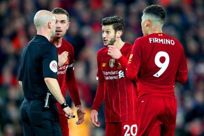 Jordan Henderson (second left), Adam Lallana and Roberto Firmino speak to referee Anthony Taylor as he calls for VAR. PA