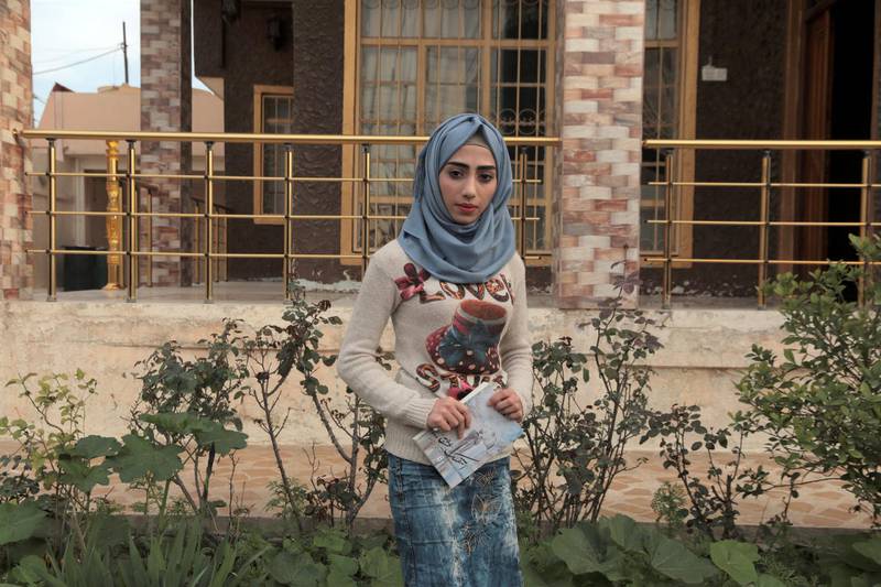Hadeel Ziad clutches a copy of her novel in her family home in the Mosul Jadida neighbourhood.
Photo: Florian Neuhof