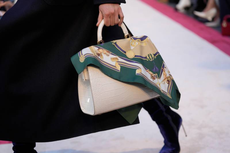 Necks and bags came adorned with scarves at Bally for autumn/winter 2023. AP