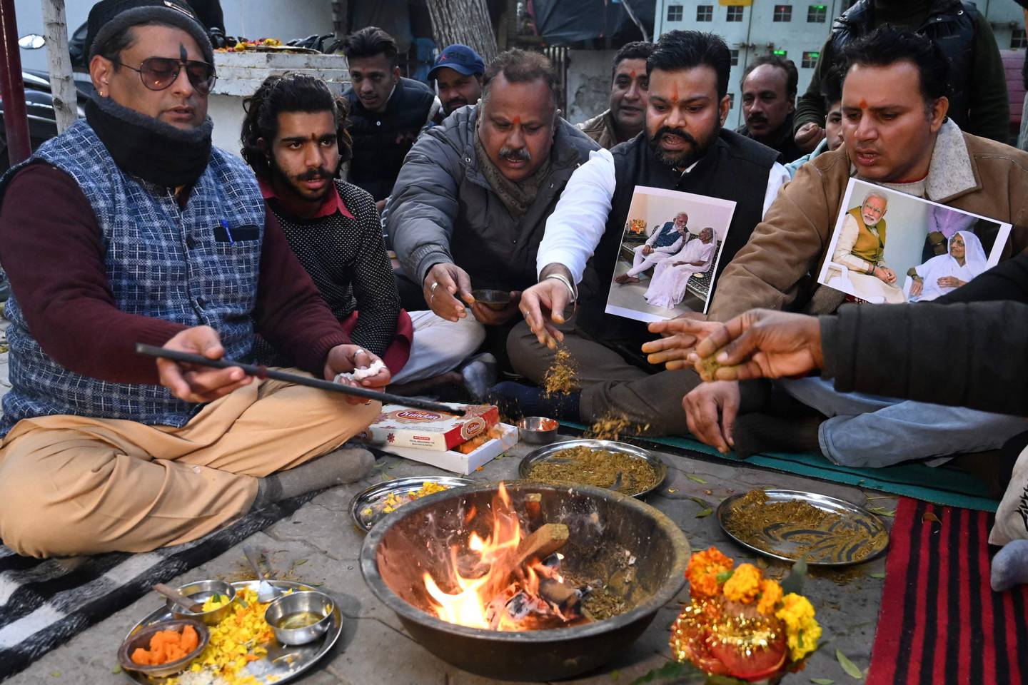 Supporters of Indian Prime Minister Narendra Modi's Bharatiya Janata Party gather at a Hindu temple in Amritsar to perform the havan ritual after Mr Modi's mother was admitted to hospital. AFP
