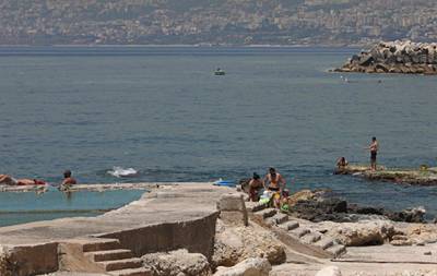 People gather on a beach in the Lebanese coastal village of Safra despite a four-day nationwide lockdown.  AFP