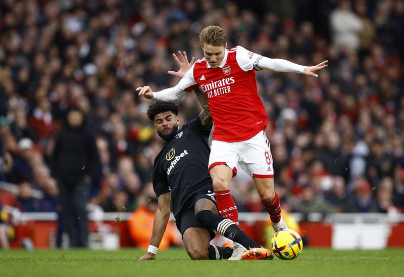 Arsenal's Martin Odegaard is tackled by Bournemouth defender Philip Billing. Reuters
