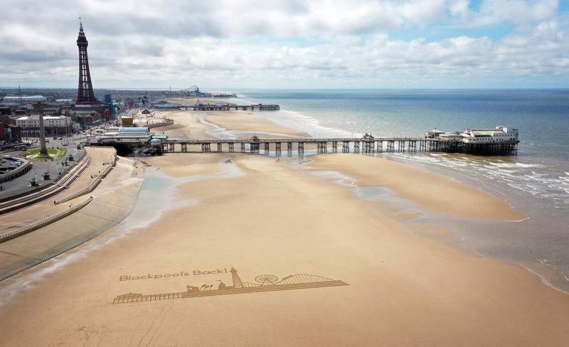 A piece of sand art, depicting the landmarks of Blackpool, north-west England, is drawn on the beach by a group of artists called Sand in your Eye to promote the town's reopening after the easing of lockdown restrictions. AFP