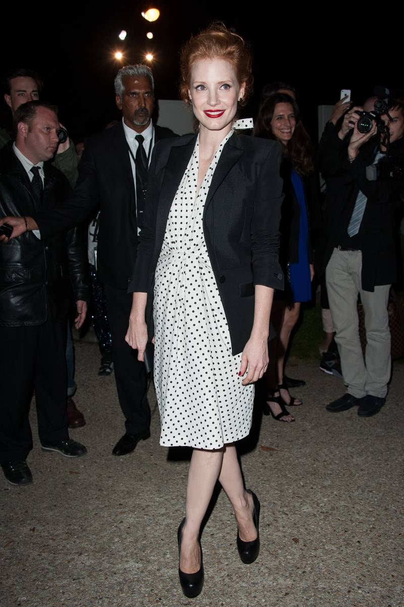 Jessica Chastain, in a monochrome polka dot dress and blazer, arrives at the Saint Laurent spring/summer 2013 show during Paris Fashion Week on October 1, 2012. Getty Images
