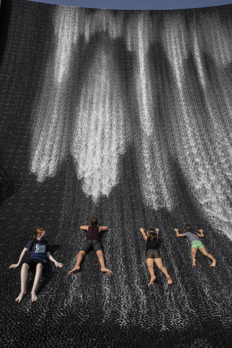Cooling down at the Expo 2020 Water feature. (Photo: Antonie Robertson / The National)