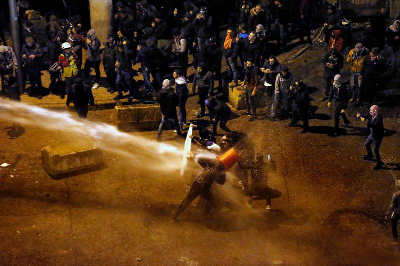 Riot police sprayed anti-government protesters with water cannons as they try to cross to the central government building during ongoing protests in Beirut, Lebanon, Saturday, Jan. 25, 2020. AP