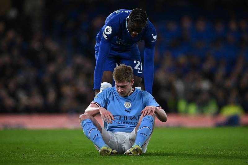Chelsea's Denis Zakaria helps Manchester City's Kevin De Bruyne to his feet. AFP