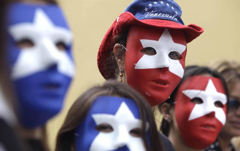 Supporters of the Venezuela opposition wear masks in Florida on February  28, 2014. Javier Galeano / AP Photo