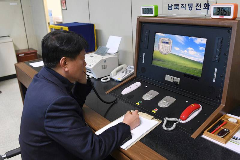 A South Korean government official talks to a North Korean officer during a phone call in 2018 at the border village of Panmunjom in Paju, South Korea.