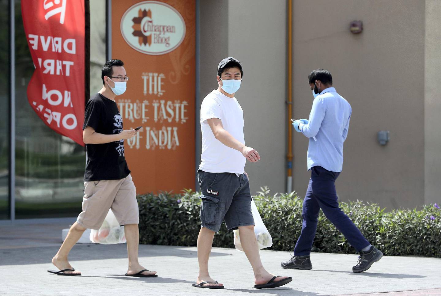 DUBAI, UNITED ARAB EMIRATES , April 05 – 2020 :- People wearing protective face mask after doing shopping at the Carrefour in Discovery Pavilion in Discovery Gardens area in Dubai. UAE government told residents to wear face mask and gloves all the times outside the home. (Pawan Singh / The National) For News/Online/Instagram.