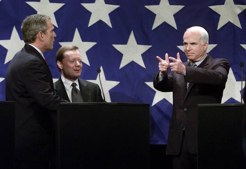 N362522 12: Republican U.S. presidential hopeful U.S. Senator John McCain (R) of Arizona gestures towards Texas Governor George W. Bush (L) as conservative activist Gary Bauer (C) looks on, Jan. 6, 2000, during the Republican candidates debate at the University of New Hampshire in Durham, NH. (Pool Photo)