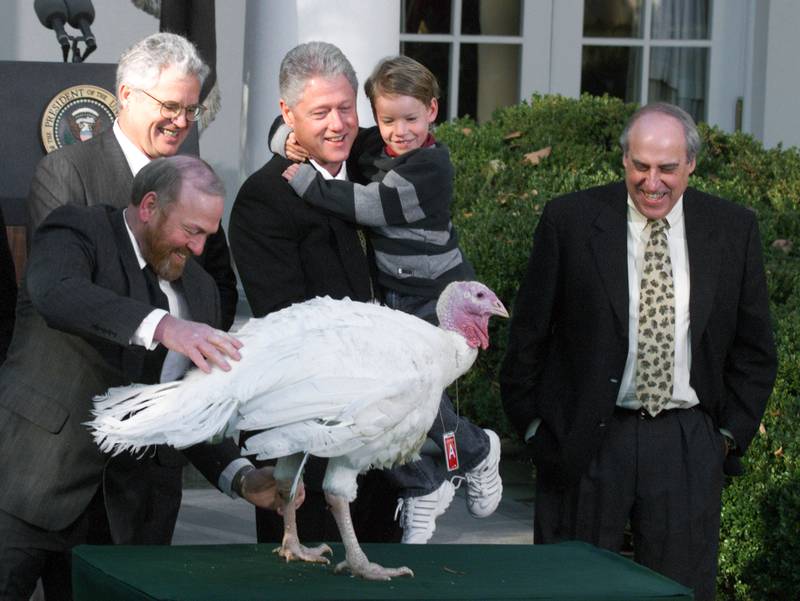 382293 05: U.S. President Bill Clinton, holding his nephew Tyler, smiles after granting a Thanksgiving pardon to a turkey named Jerry, November 22, 2000 in the Rose Garden of the White House. Clinton is joined by Nickolas Feidt, left, who raised the turkey in Wisconsin, and by Jerry Jerome, 2nd left, chairman of the National Turkey Federation, and Secretary of Agriculture Dan Glickman, right. (Photo by Mark Wilson/Newsmakers)