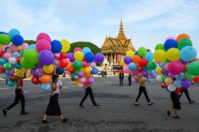 Students carry balloons as part of independence day celebrations in Phnom Penh, as Cambodia marks 70 years of independence from France. AFP