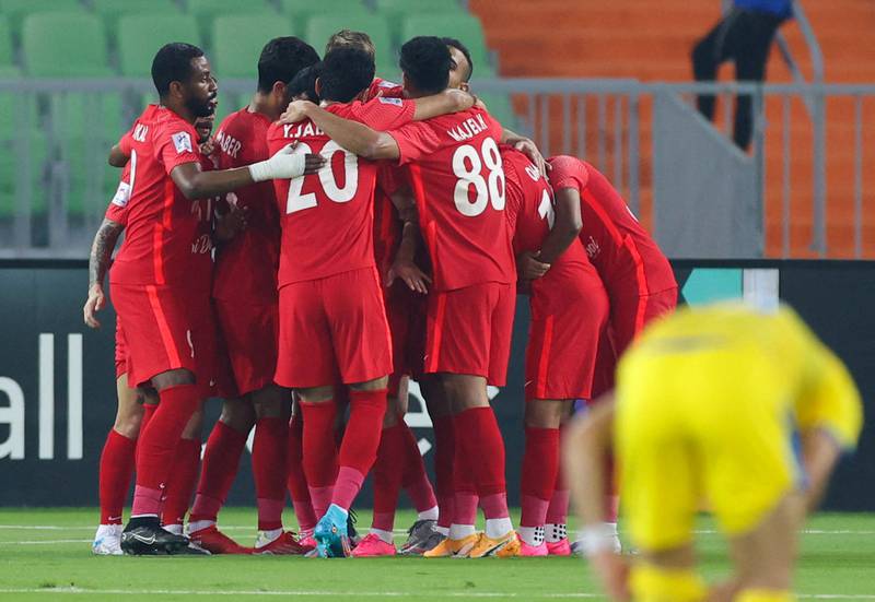 Shabab Al Ahli players celebrate their opening goal against Al Gharafa. AFP
