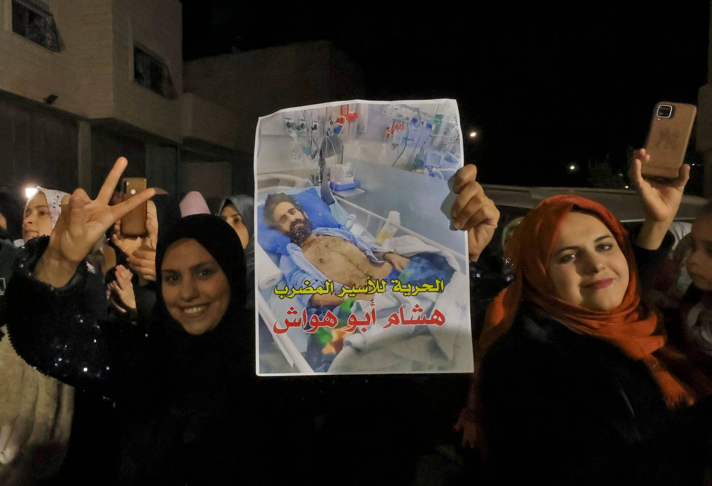 Palestinians gather outside the house of Hisham Abu Hawash, after he ended his hunger strike, on January 4. AFP