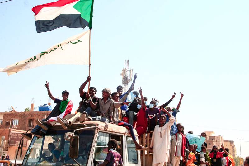 Demonstrators fly the Sudanese flag as they mark the third anniversary of the uprising that deposed the government of Omar Al Bashir, in the capital Khartoum. All photos: AFP