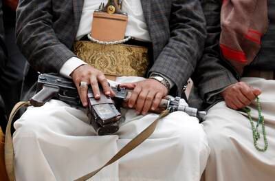 A Houthi supporter holds a gun during a vigil marking the second anniversary of the killing of Iranian military commander Qassem Suleimani and Iraqi militia commander Abu Mahdi Al Muhandis in a US drone attack, at a mosque in Sanaa, Yemen, on January 3. EPA