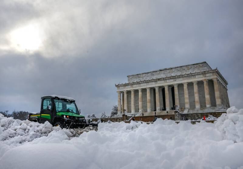 A snowplow removes snow around the Lincoln Memorial following the storm in Washington. Reuters