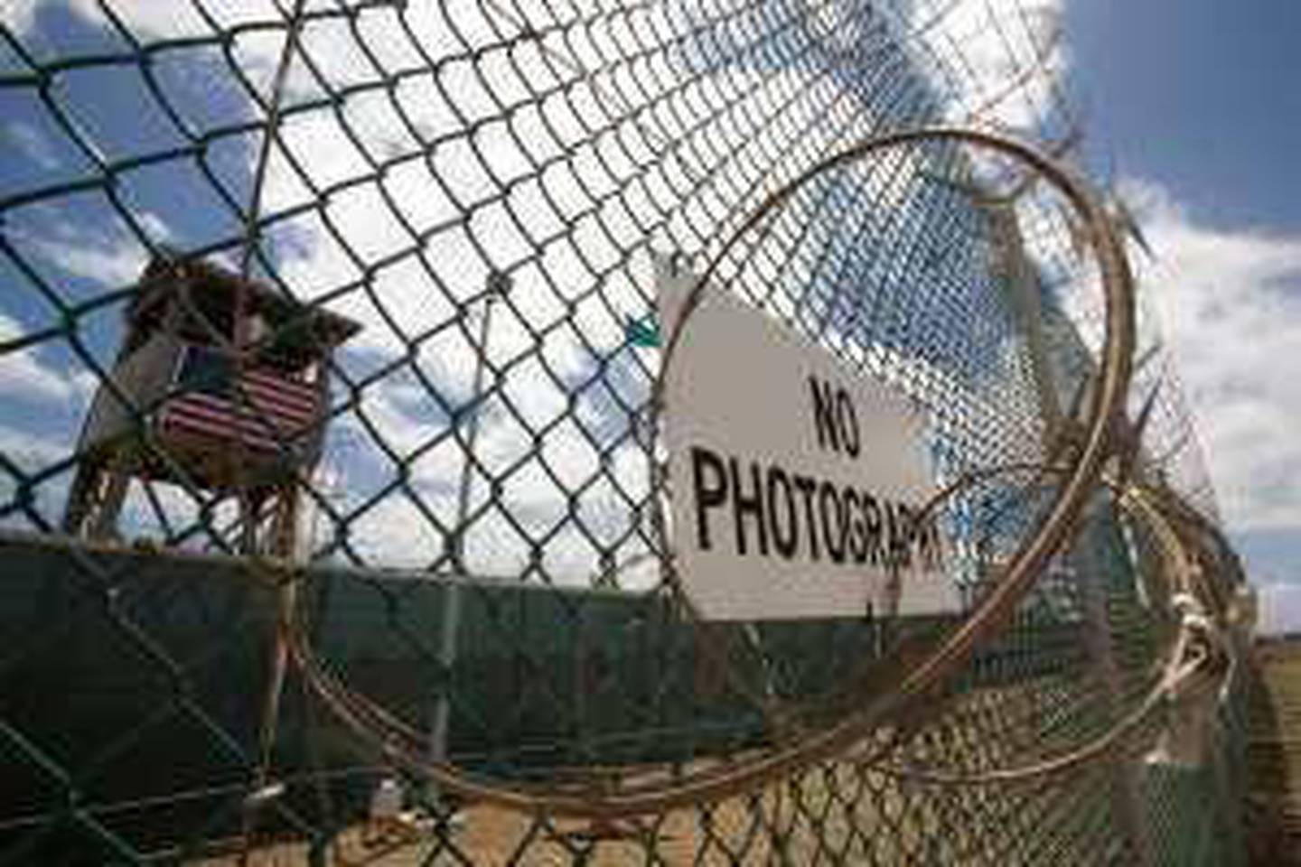 The outer fence and guard tower at Camps 1 & 4 at Camp Delta at the US Naval Station in Guantanamo Bay, Cuba, 24 April 2007 mans his security station. US Militrary officials list about 385 current detainees of various threat levels and nationalities being held on the US base in Cuba captured in the US war on terror. AFP Photo/Paul J. Richards