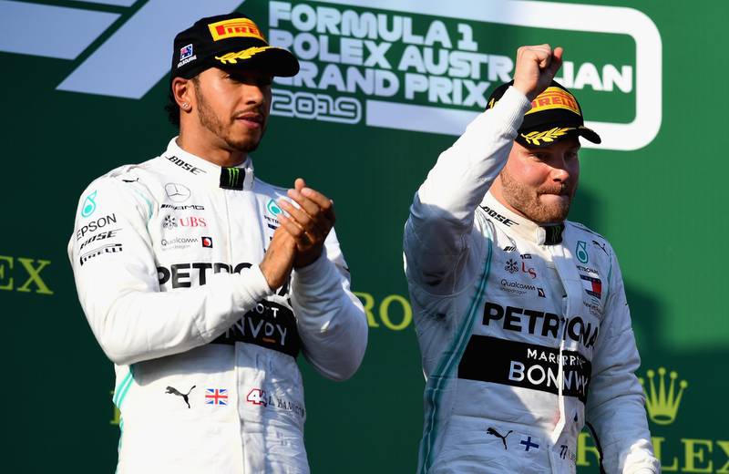 MELBOURNE, AUSTRALIA - MARCH 17: Race winner Valtteri Bottas of Finland and Mercedes GP and second placed Lewis Hamilton of Great Britain and Mercedes GP celebrate on the podium during the F1 Grand Prix of Australia at Melbourne Grand Prix Circuit on March 17, 2019 in Melbourne, Australia.  (Photo by Clive Mason/Getty Images)
