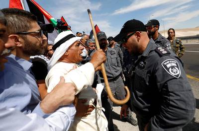 Demonstrators shout slogans in front of Israeli border police officers as they protest against Israel's plan to demolish the Palestinian Bedouin village of Khan al-Ahmar, in the occupied West Bank.  Reuters
