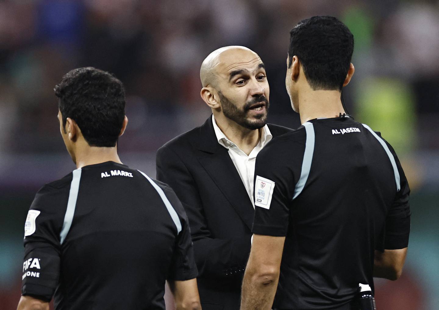 Morocco coach Walid Regragui talks with referee Abdulrahman Al Jassim after the match. Reuters