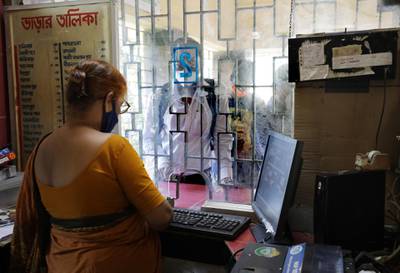 Passengers wait at a railway ticket counter after service reopened for the public after seven months of closure due to the coronavirus pandemic crisis, in Kolkata, India. EPA