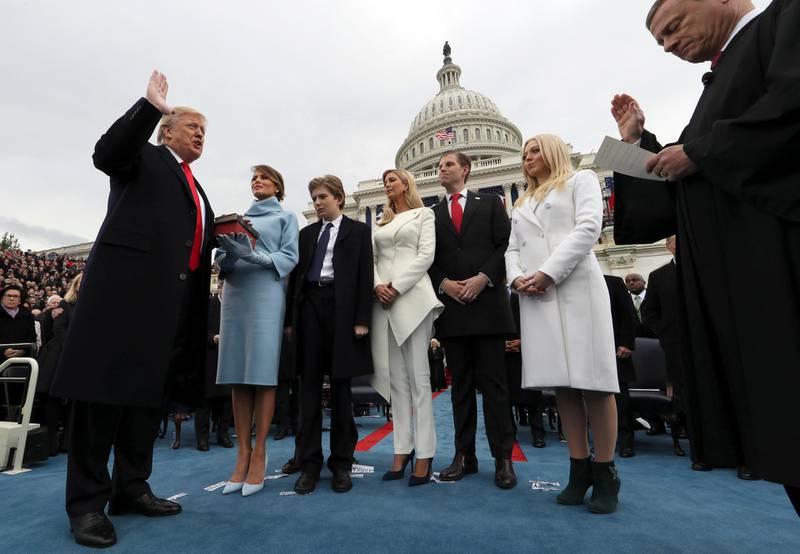 FILE - In this Jan. 27, 2017, file photo President Donald Trump takes the oath of office from Chief Justice John Roberts, as his wife Melania holds the Bible, and with his children Barron, Ivanka, Eric and Tiffany on Capitol Hill in Washington. (Jim Bourg/Pool Photo via AP, File)