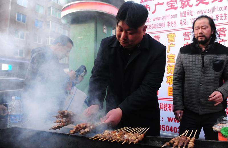 Like Kim, the vendor has a penchant for high-buttoned jackets, and a smoking habit.