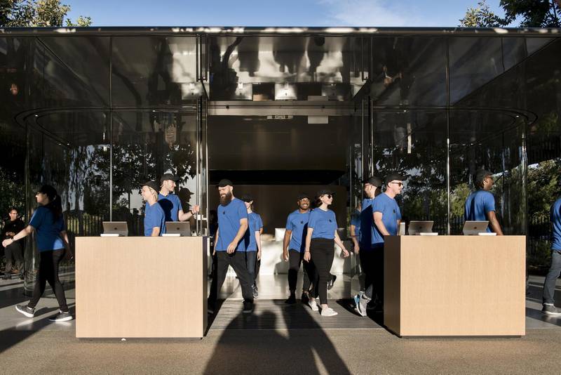 Employees walk out to kiosks ahead of the Apple event. Bloomberg