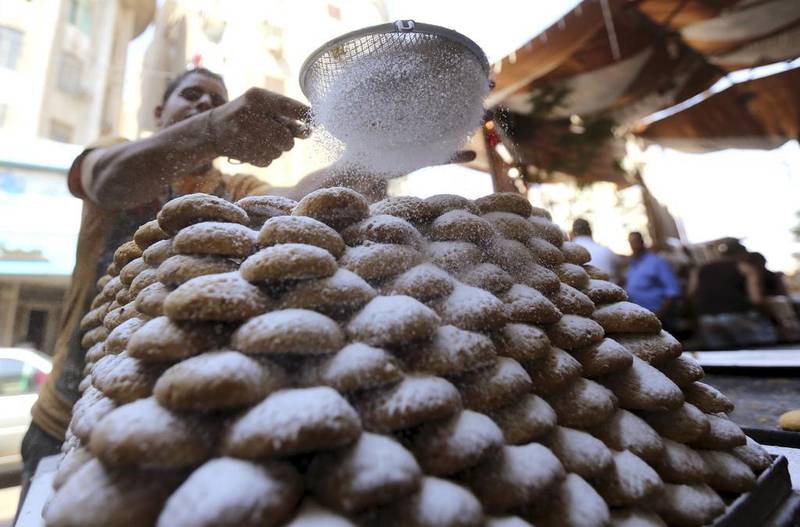 An Egyptian worker makes traditional sweets – known as Kahk – as part of celebrations for the Eid Al Fitr festival, at a bakery in Cairo. Mohamed Abd El Ghany/Reuters