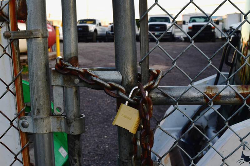 A lock fastens a chained link fence at Four Seasons Landscaping. Reuters