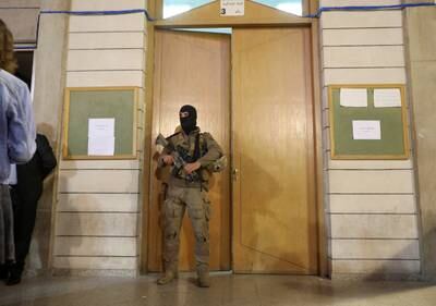 A soldier stands guard as ballots are counted at the Justice Palace. Reuters