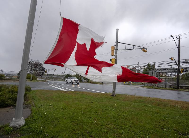 A Canadian flag struggles against the high winds in Dartmouth, Nova Scotia. AP