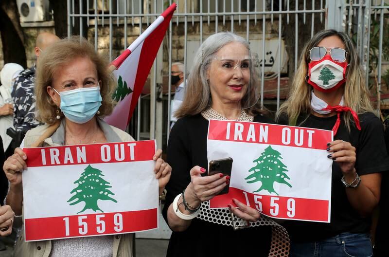 Anti-government protesters hold placards during a rally in support of Judge Tareq Bitar amid alleged Hezbollah interference in the investigation of the port explosion, in Beirut. EPA