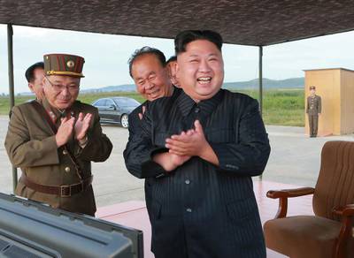 FILE - In this undated file photo distributed on Sept. 16, 2017, by the North Korean government, North Korean leader Kim Jong Un, right, celebrates what was said to be the test launch of an intermediate range Hwasong-12 missile at an undisclosed location in North Korea. North Korea says it will never give up its nuclear weapons as long as the United States and its allies continue their â€œblackmail and war drillsâ€ at its doorstep. Independent journalists were not given access to cover the event depicted in this image distributed by the North Korean government. The content of this image is as provided and cannot be independently verified. (Korean Central News Agency/Korea News Service via AP, File)