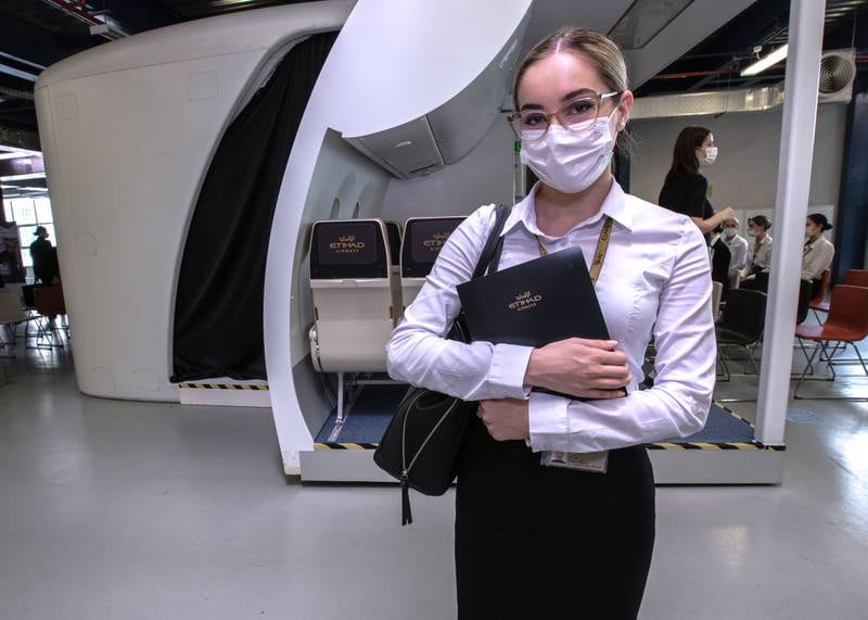 A new recruit with her cabin crew quick reference handbook at the Etihad Aviation Training Centre at Khalifa City in Abu Dhabi. Victor Besa / The National