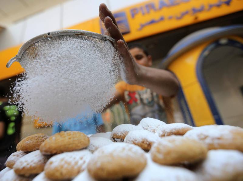 An Egyptian worker makes traditional sweets, "Kahk", as part of the celebration of the Eid al-Fitr festival, at a bakery in Cairo July 27, 2014. Picture taken July 27, 2014. REUTERS/Mohamed Abd El Ghany (EGYPT - Tags: RELIGION FOOD SOCIETY) - GM1EA7S18Q701