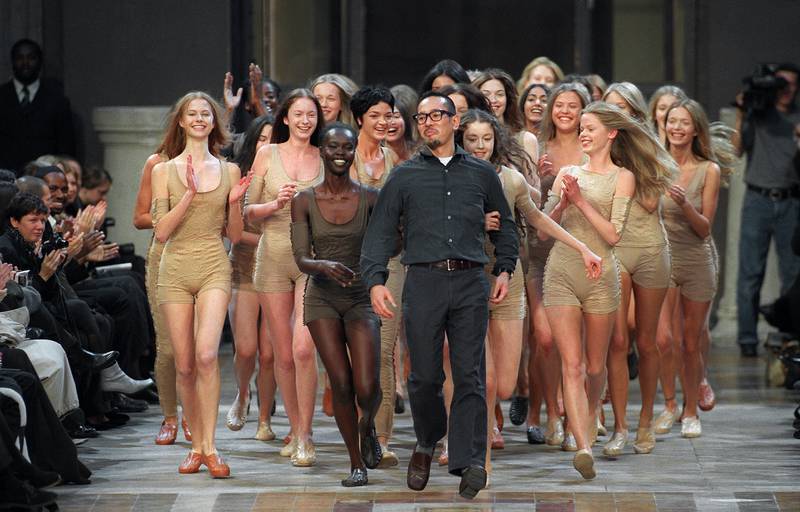 Models push fashion designer Naoki Takizawa up the catwalk at the end of the presentation of Issey Miyake's spring/summer 2000 ready-to-wear collection at Paris Fine arts school. AFP