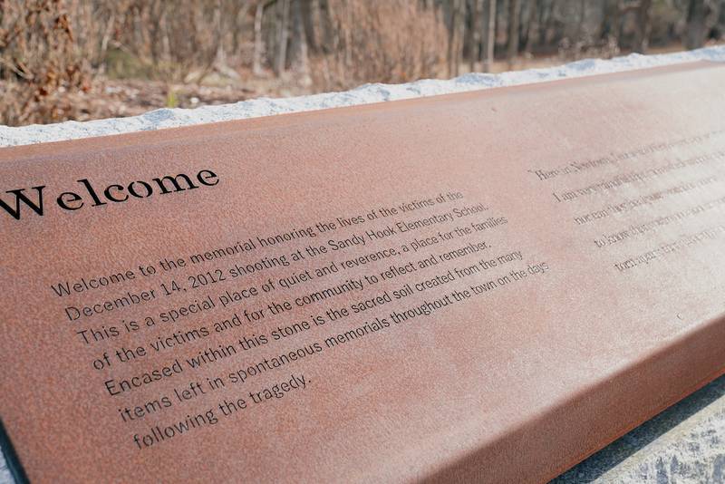 A plaque welcomes visitors to the Sandy Hook Memorial. Inside the stone block are the incinerated remains of teddy bears, photos, flowers and letters that make up the 'sacred soil' of the memorial. Reuters
