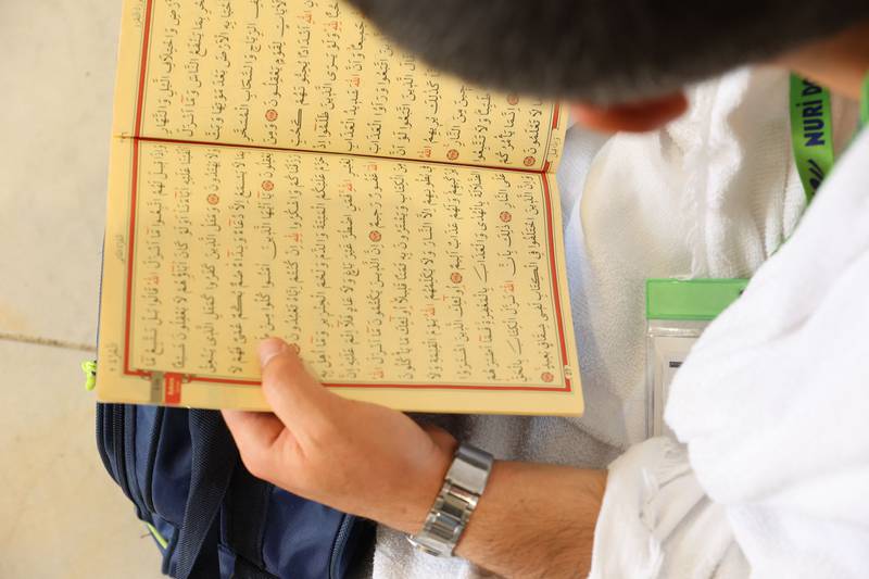 A Muslim worshipper reads the Quran on the first day of the holy month