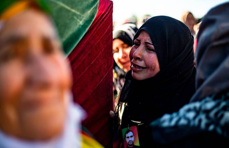 Relatives mourn at a funeral for two Syrian Democratic Forces (SDF) fighters in the Syrian Kurdish-majority city of Qamishli, after they were killed by a Turkish military drone, according to Kurdish security officials.  AFP