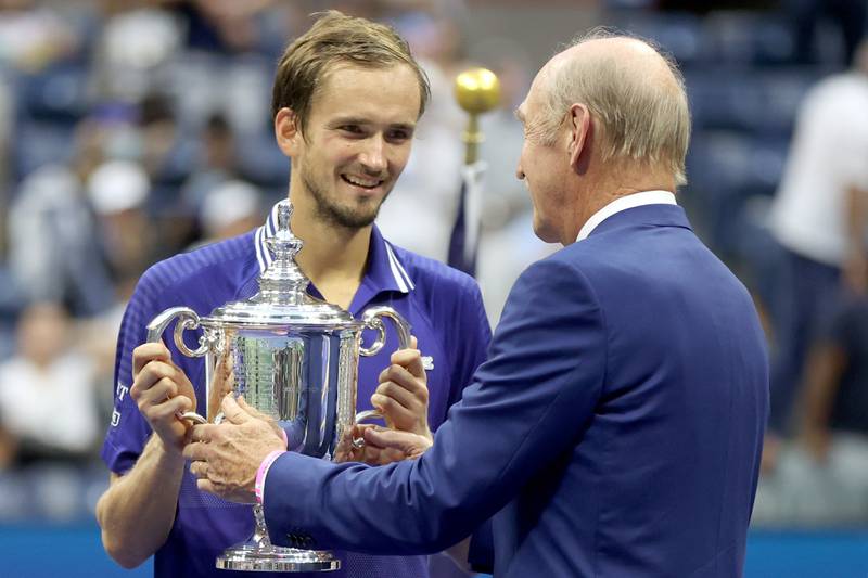 Daniil Medvedev of Russia is awarded the championship trophy by former tenner player Stan Smith after defeating Novak Djokovic of Serbi. AFP
